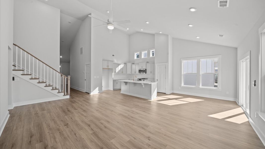 Elegant family room with soaring two-story ceilings and abundant natural light in this first-class DRB Homes design