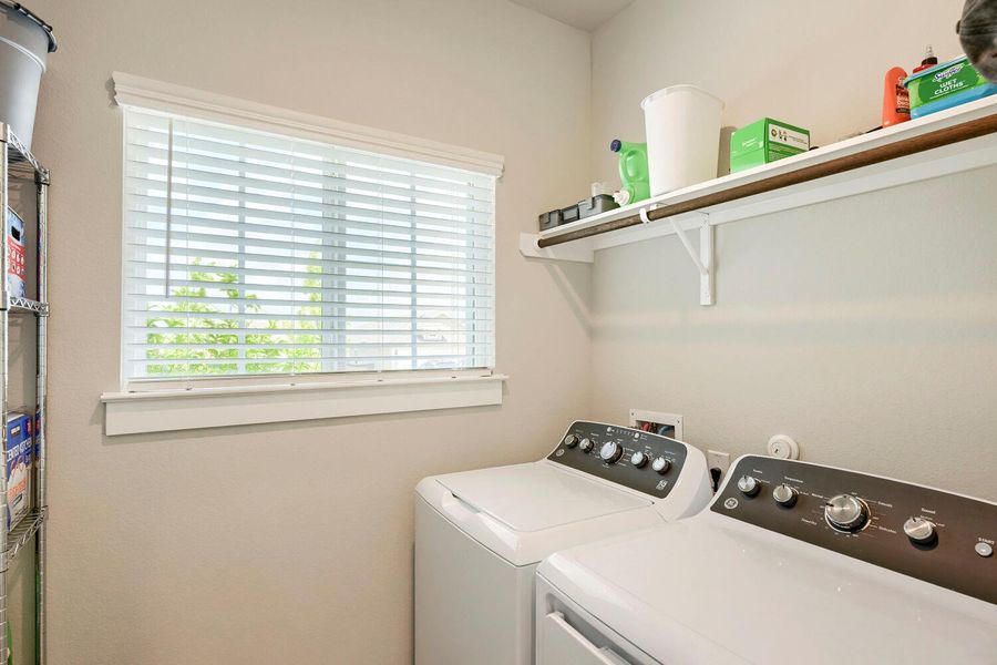 A dedicated laundry room with washer and dryer units for domestic chores. A dedicated laundry room with washer and dryer units for domestic chores.