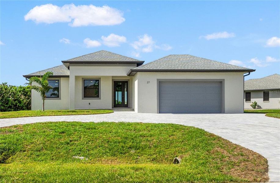Front exterior of a new home in , Rotonda West, FL, highlighting curb appeal (Image 1).