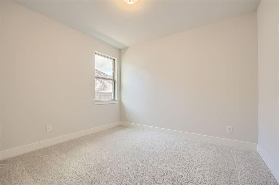 Unfurnished room with baseboards and light carpet Unfurnished room with baseboards and light carpet