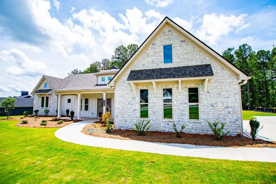 Front exterior of a new home in WOODMONT RESERVE, Roopville, GA, highlighting curb appeal (Image 29).