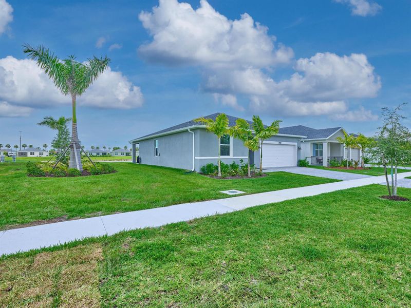 Front exterior of a new home in Azalea, Port St. Lucie, FL, highlighting curb appeal (Image 2).