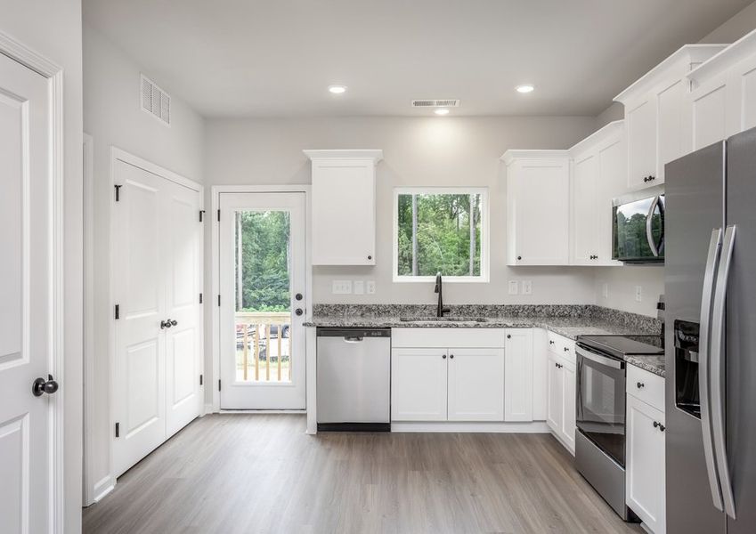 The kitchen comes with stainless-steel appliances.