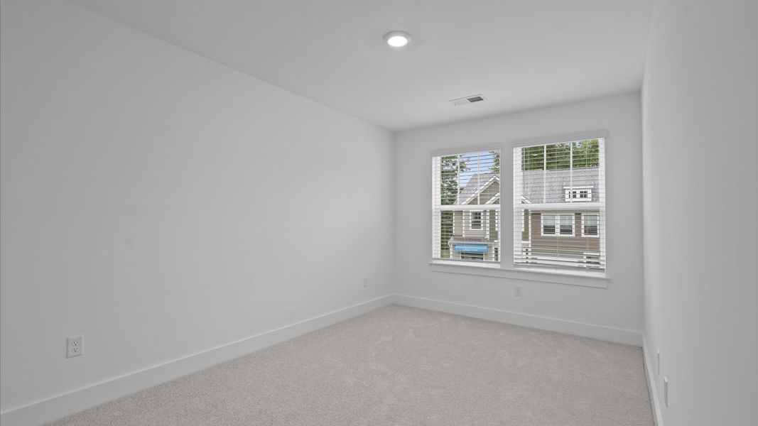 Highly functional bedroom with walk-in closet and tasteful carpet for a restful retreat Highly functional bedroom with walk-in closet and tasteful carpet for a restful retreat