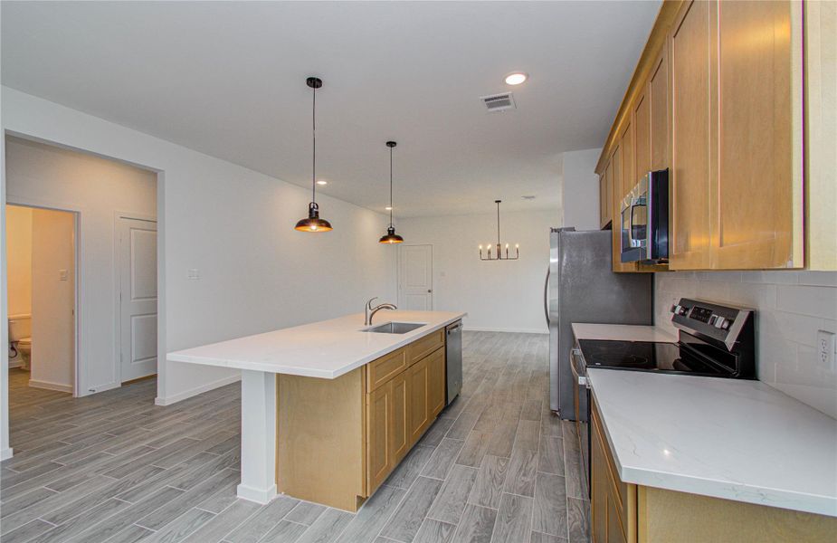 KitchenModern kitchen with white quartz countertops, stainless steel appliances, and ample cabinet space.