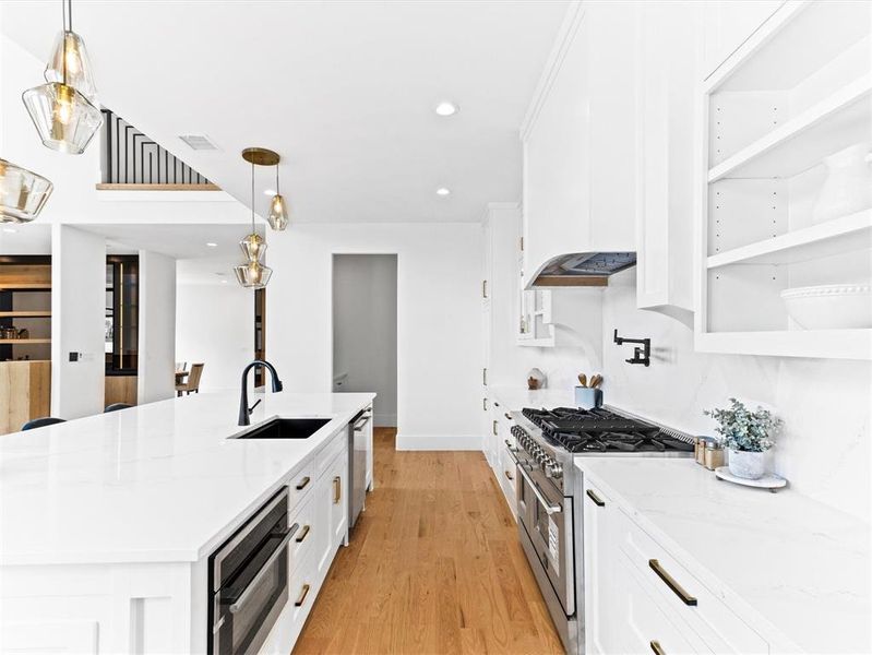 Kitchen with sink, white cabinets, and appliances with stainless steel finishes