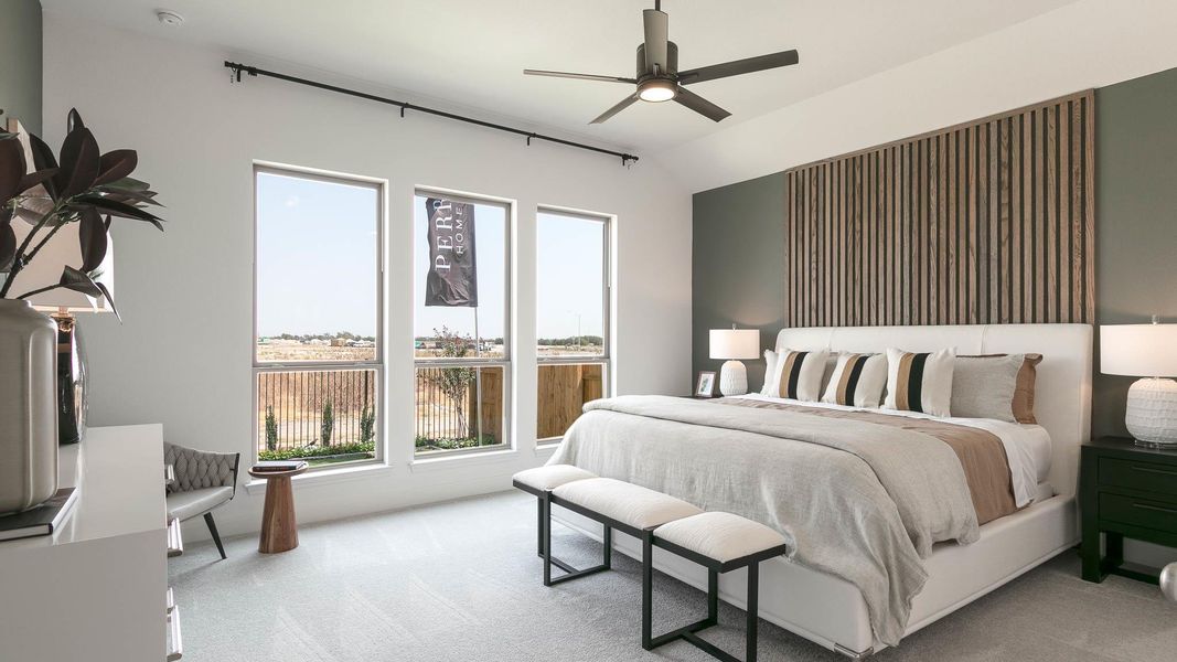 Bedroom with light carpet and a ceiling fan