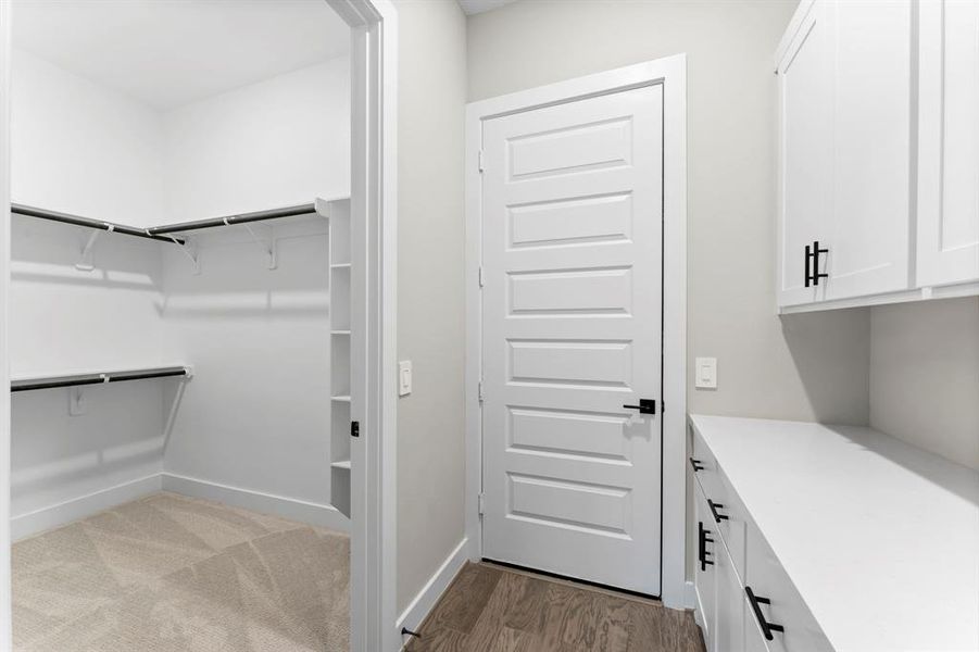 Generously sized walk-in closet, a door leading to the single garage, and a private drop zone for added convenience.