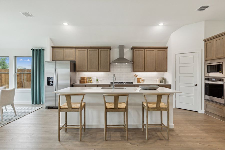 Kitchen in the Gilmour home plan by Trophy Signature Homes – REPRESENTATIVE PHOTO