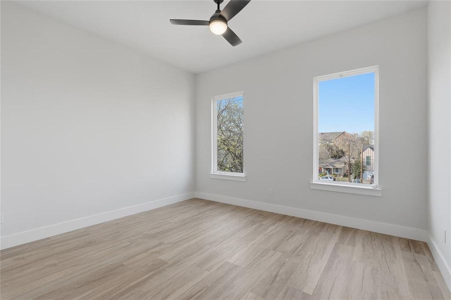 Unfurnished room with light wood-type flooring and ceiling fan Unfurnished room with light wood-type flooring and ceiling fan