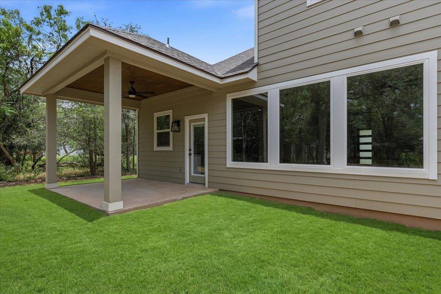 Backyard covered patio with new grass in privacy backyard