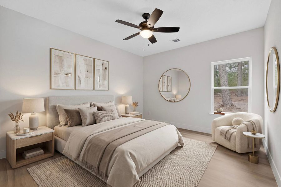 Spacious bedroom featuring light-toned walls, wood-finish flooring, a ceiling fan, and a large window overlooking natural scenery Spacious bedroom featuring light-toned walls, wood-finish flooring, a ceiling fan, and a large window overlooking natural scenery
