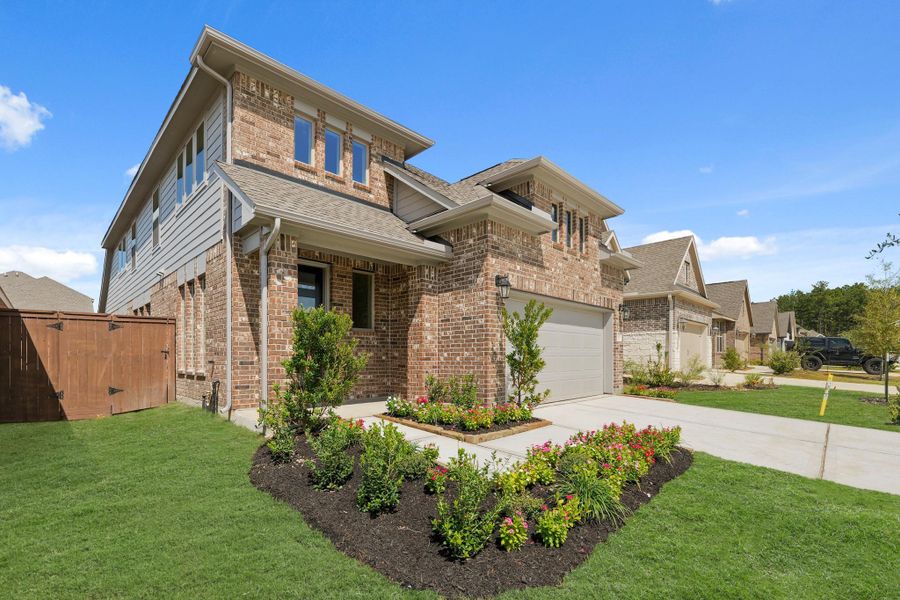 Front exterior of a new home in The Trails, New Caney, TX, highlighting curb appeal (Image 17).