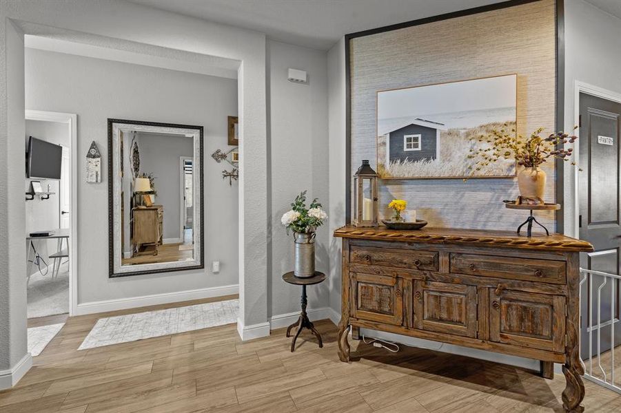 Hall with light hardwood / wood-style flooring