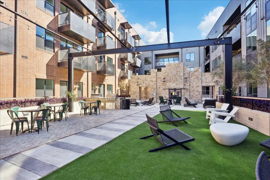 An inviting courtyard beckons with outdoor lounging areas and a built-in barbecue station. An inviting courtyard beckons with outdoor lounging areas and a built-in barbecue station.