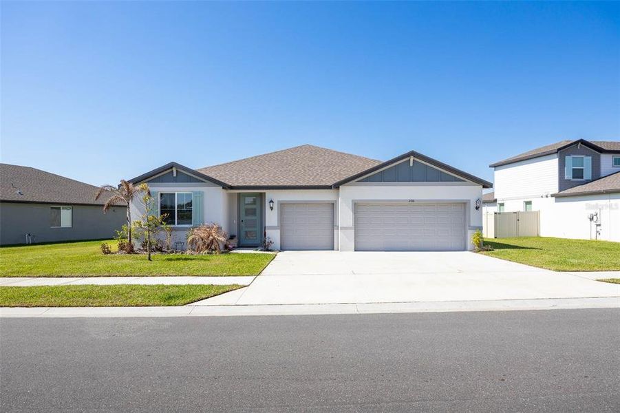 Front exterior of a new home in The Grove at Stuart Crossing - Signature Series, Bartow, FL, highlighting curb appeal (Image 23). Front exterior of a new home in The Grove at Stuart Crossing - Signature Series, Bartow, FL, highlighting curb appeal (Image 23).