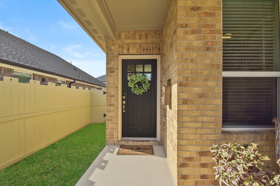 Exterior details and patio area of a home in Harper's Preserve - Traditional Series, Conroe (Image 20).