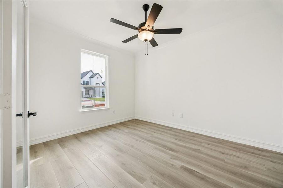 Spacious secondary bedroom with large windows. *Model representation.