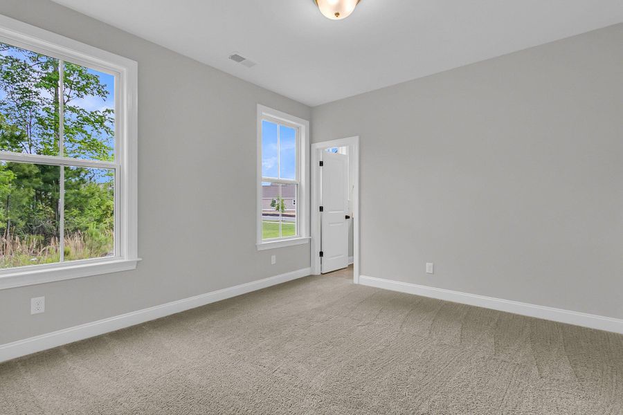 Spacious, unfurnished interior of a new home in Tidewater at Lakes of Cane Bay, Summerville (Image 13).