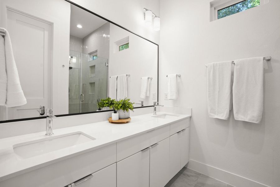 The primary ensuite bathroom is a refreshing spa-like retreat with refined modern finishes including a dual vanity and custom cabinetry. The primary ensuite bathroom is a refreshing spa-like retreat with refined modern finishes including a dual vanity and custom cabinetry.