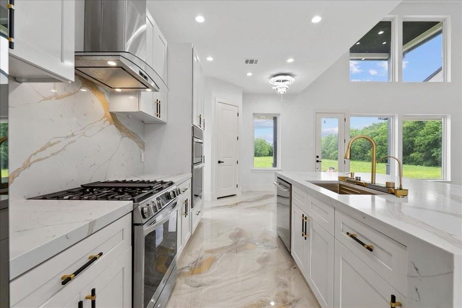 Gourmet kitchen with quartz counters, gas range, and custom finishes.