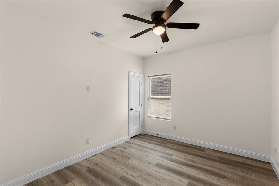 Unfurnished room with ceiling fan and light hardwood / wood-style floors