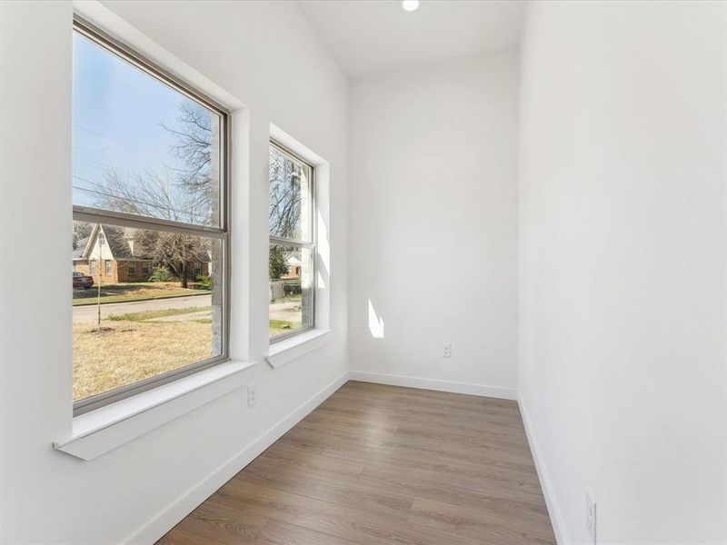 Empty room with recessed lighting, wood finished floors, and baseboards