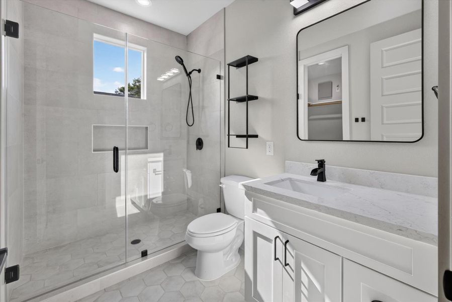 This modern bathroom features a sleek glass-enclosed shower with green tile, a stylish vanity with ample storage, and a neutral color palette. The space is enhanced by elegant fixtures and tasteful decor, creating a clean and inviting atmosphere. This modern bathroom features a sleek glass-enclosed shower with green tile, a stylish vanity with ample storage, and a neutral color palette. The space is enhanced by elegant fixtures and tasteful decor, creating a clean and inviting atmosphere.