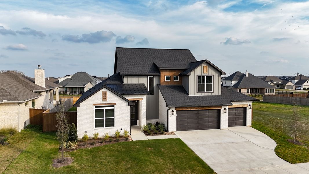 Front exterior of a new home in Greens Prairie Reserve, College Station, TX, highlighting curb appeal (Image 31).