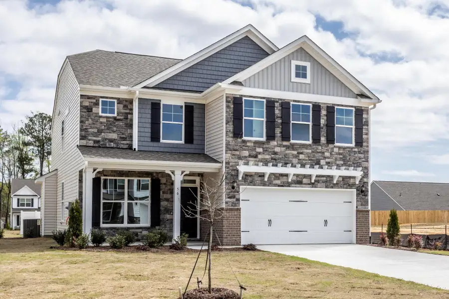 Front exterior of a new home in Daniel Farms, Benson, NC, highlighting curb appeal (Image 2).