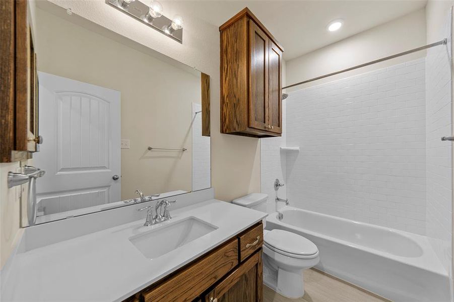 Full bathroom featuring vanity, toilet, and bathtub / shower combination