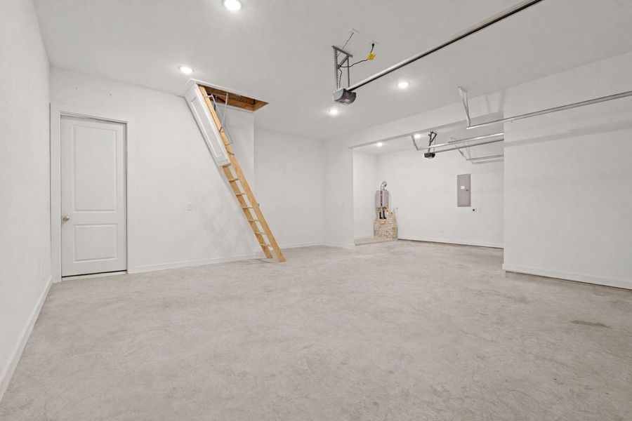 Oversized 3-car garage offering ample room for vehicles, storage, and workspace needs. Features high ceilings, convenient attic access for additional storage and a 240 volt outlet for EV charging.
