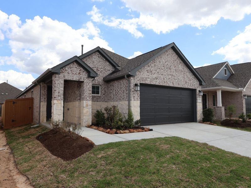 Front exterior of a new home in Marvida, Cypress, TX, highlighting curb appeal (Image 2). Front exterior of a new home in Marvida, Cypress, TX, highlighting curb appeal (Image 2).