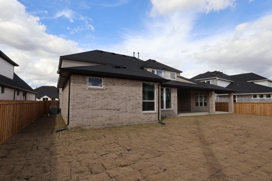 Exterior details and patio area of a home in Dunham Pointe, Cypress (Image 24).