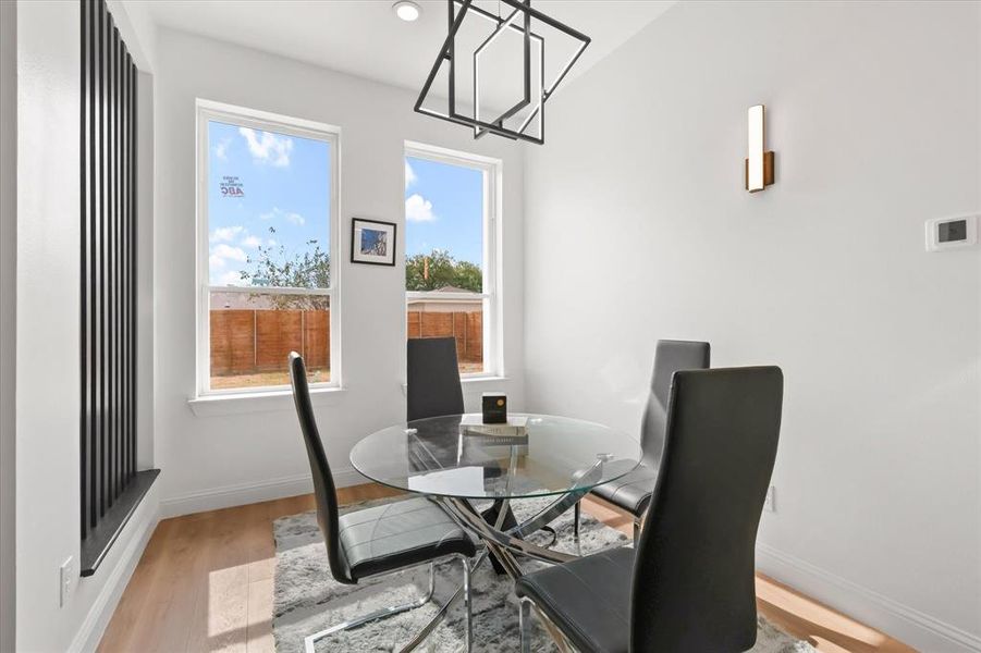 Dining room with wood finished floors, a chandelier, and recessed lighting Dining room with wood finished floors, a chandelier, and recessed lighting