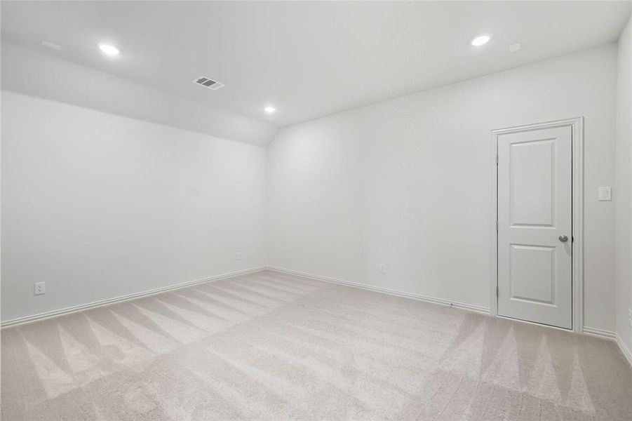 Unfurnished room featuring light carpet, recessed lighting, and vaulted ceiling Unfurnished room featuring light carpet, recessed lighting, and vaulted ceiling