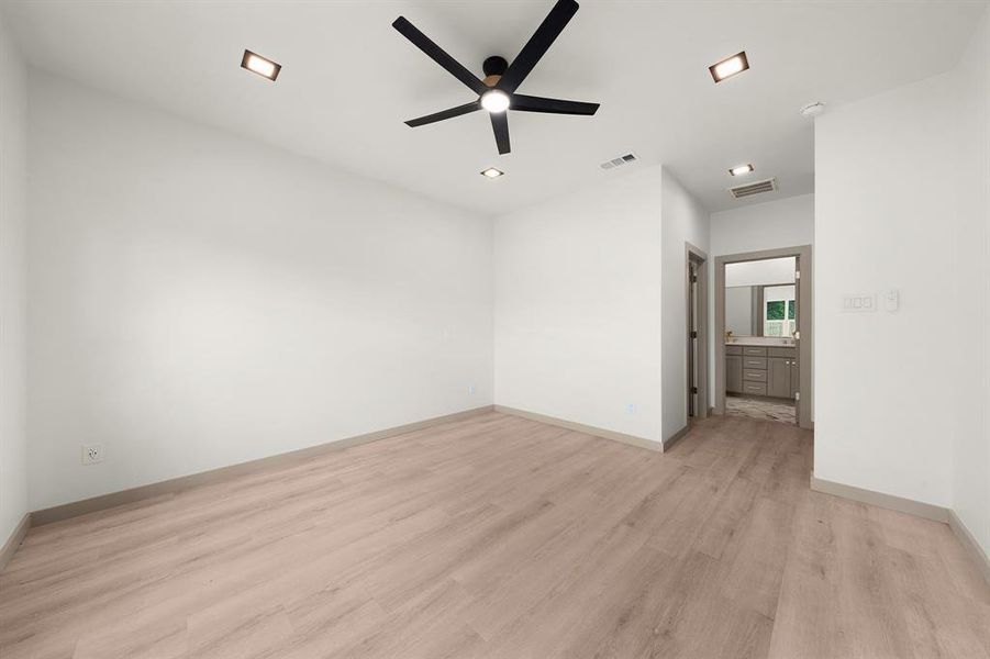 Unfurnished bedroom featuring baseboards, light wood-style flooring, and visible vents