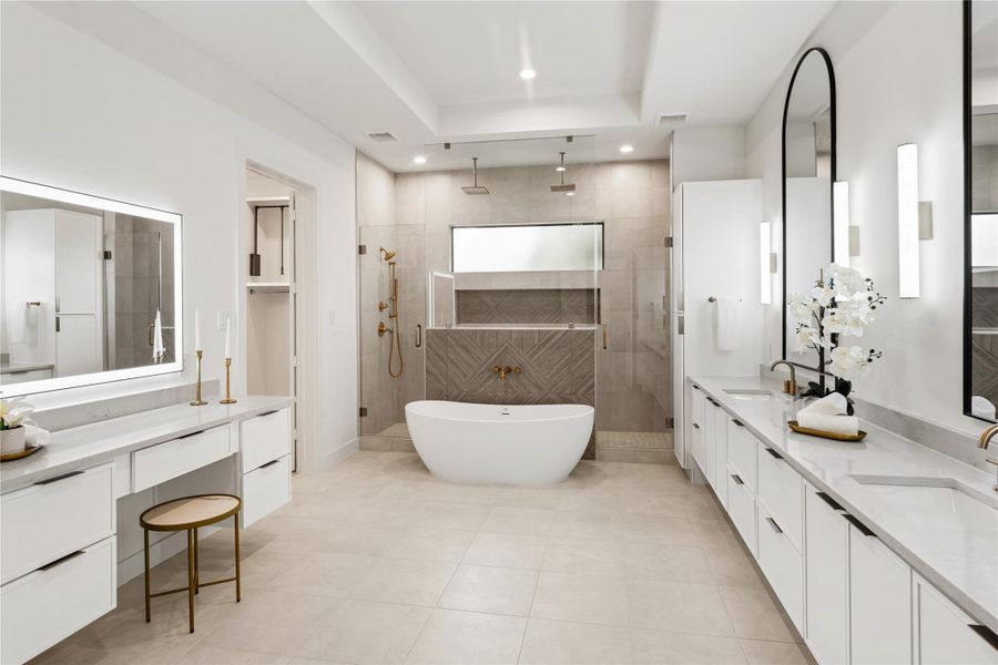 The spacious primary bathroom's modern design showcases sleek surfaces and clean lines that create an atmosphere of refined luxury. European style floating cabinets provide plenty of functional storage while expressing a clean and modern aesthetic.