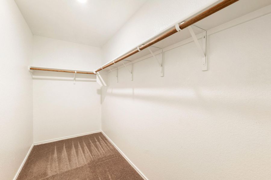 Ample storage solutions await in this naturally illuminated walk-in closet. Ample storage solutions await in this naturally illuminated walk-in closet.