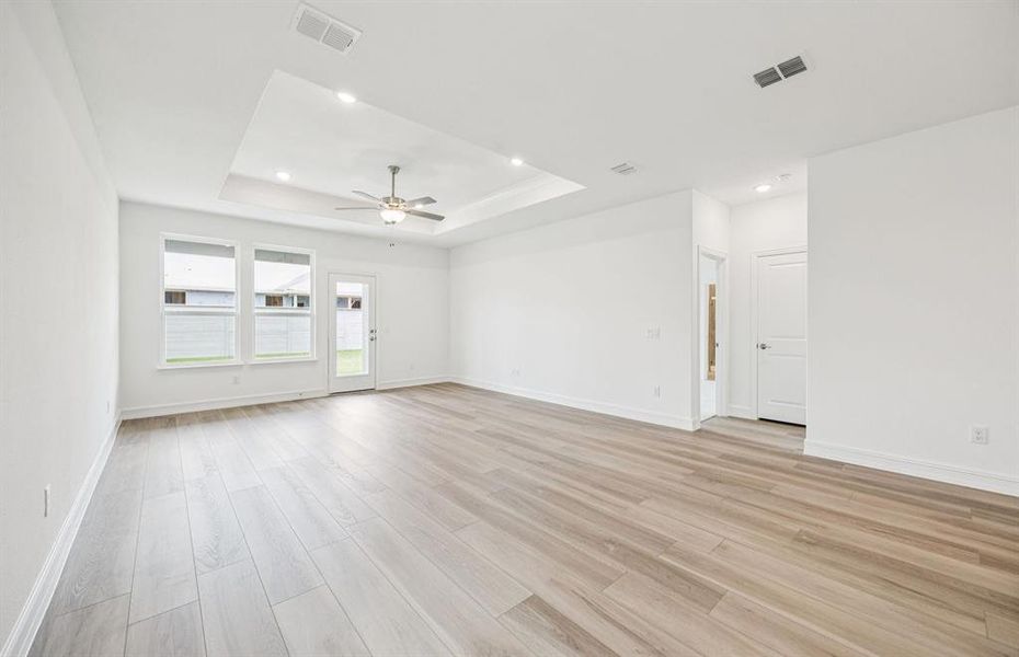 Open concept gathering room creating a spacious and inviting atmosphere *Real home pictured