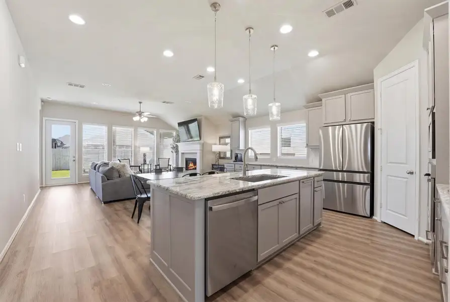 Open plan kitchen with breakfast island, overlooking dining area and family room