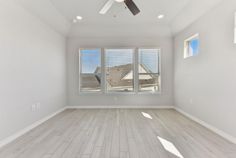 Unfurnished room featuring light wood finished floors, ceiling fan, recessed lighting, and vaulted ceiling Unfurnished room featuring light wood finished floors, ceiling fan, recessed lighting, and vaulted ceiling