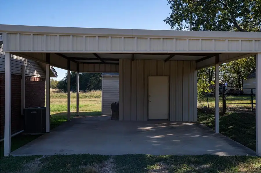 View of outbuilding featuring a carport