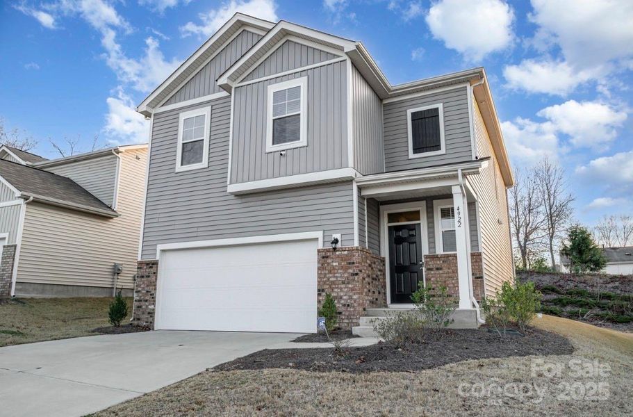 Front exterior of a new home in Freedom Greene, Charlotte, NC, highlighting curb appeal (Image 1). Front exterior of a new home in Freedom Greene, Charlotte, NC, highlighting curb appeal (Image 1).