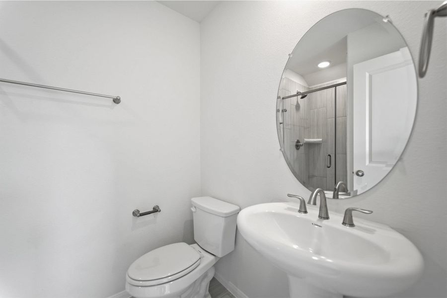 Bathroom featuring toilet and a stall shower