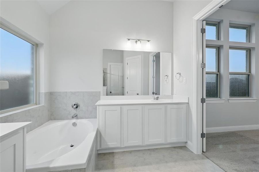 Full bathroom with double vanity and a garden tub Full bathroom with double vanity and a garden tub