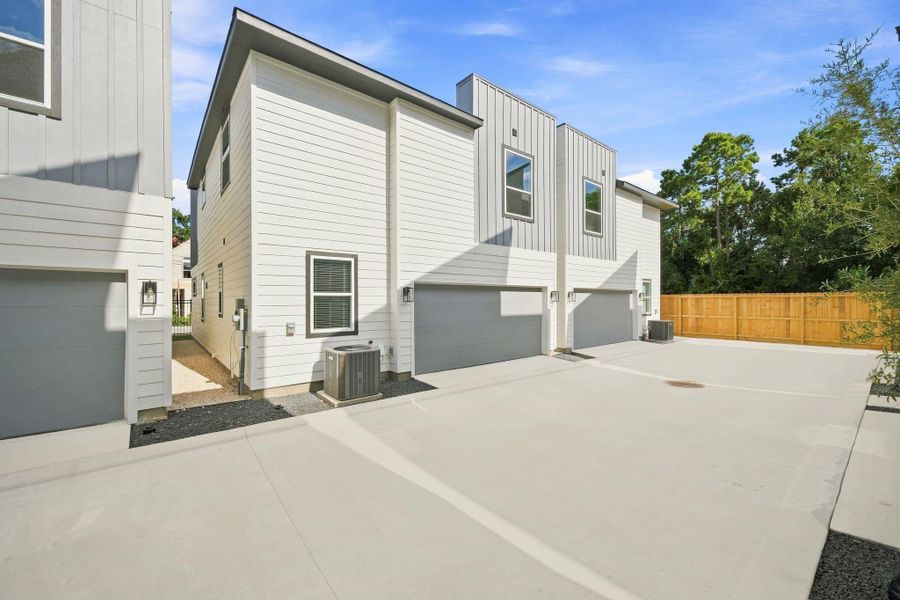 Another view of the private community drive and rear-entry garages, showcasing the clean, thoughtfully designed layout of Highland Heights Crossing.