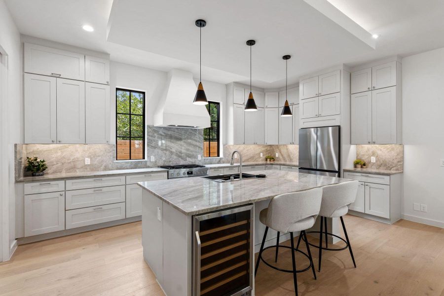 An immaculate kitchen showcases premium stainless steel appliances and abundant counter space. An immaculate kitchen showcases premium stainless steel appliances and abundant counter space.