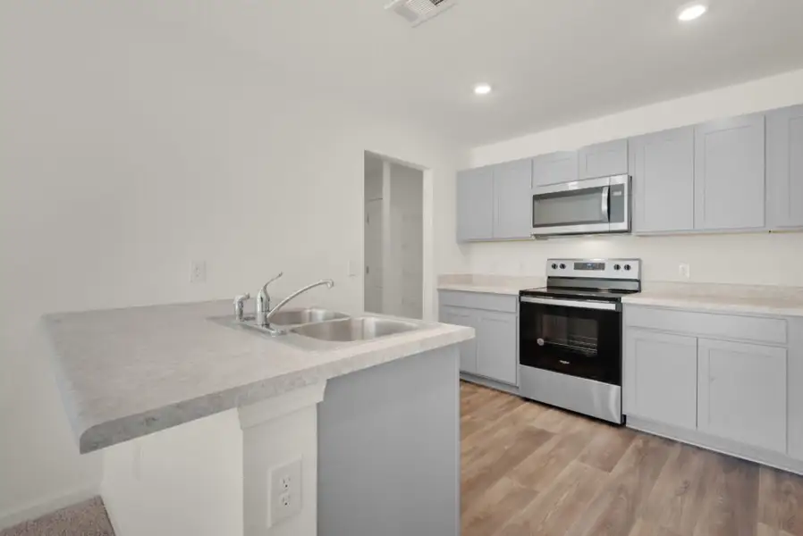Representative furnished interior of a home built from the Maddox by Holiday Builders in Floridatown, Pace (Image 3).