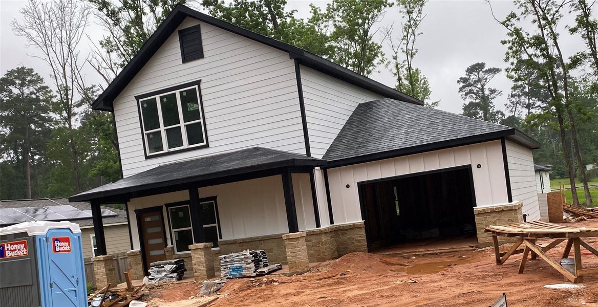 Painted white with black trim. Brand new construction with one car garage.